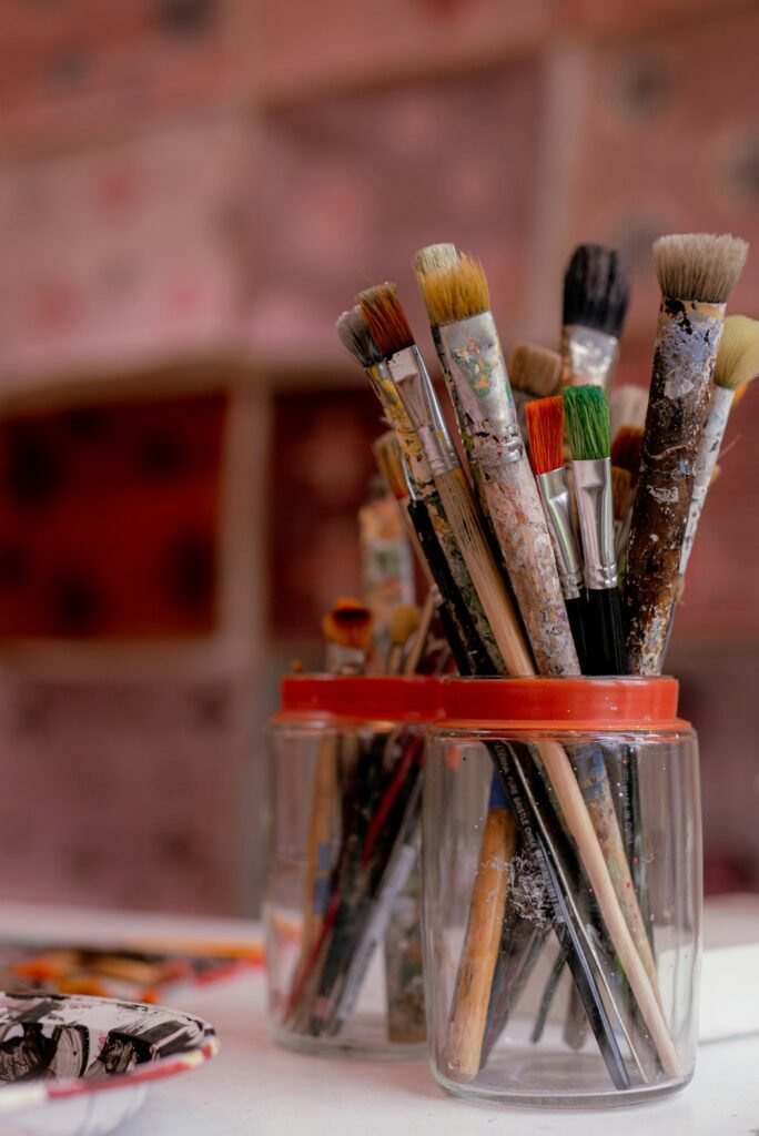 Paintbrush resting in a jar in an art studio